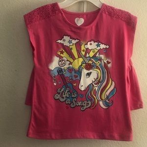 Matching t-shirt and skirt set in pink, with unicorn art on t-shirt.